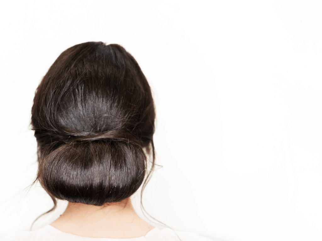 Woman modeling low loop bun  updo hairstyle