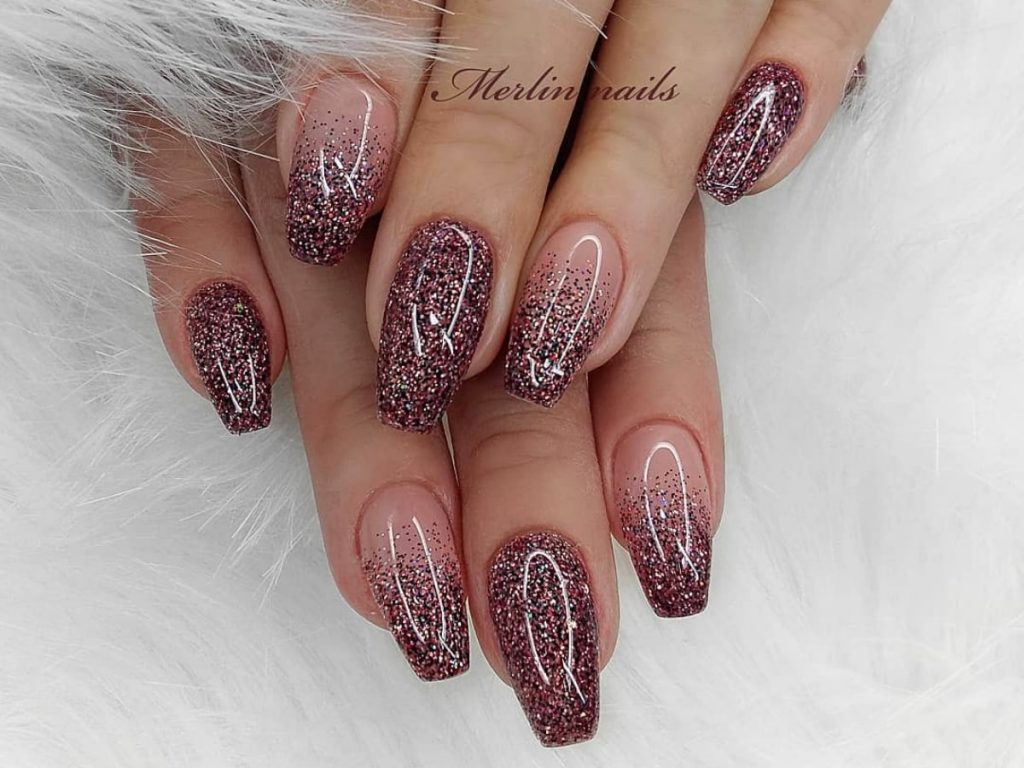 Natural to dark color bridal nails that are paired with paint multi-colored glitter.