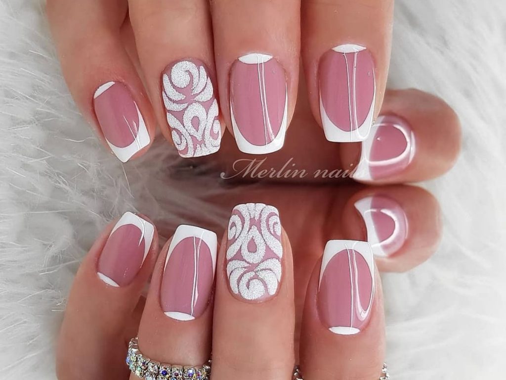 Light pink with white accents and glitter design wedding nails that shine.