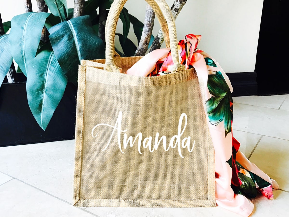 A custom bridesmaid gift bag with their name embroidered.