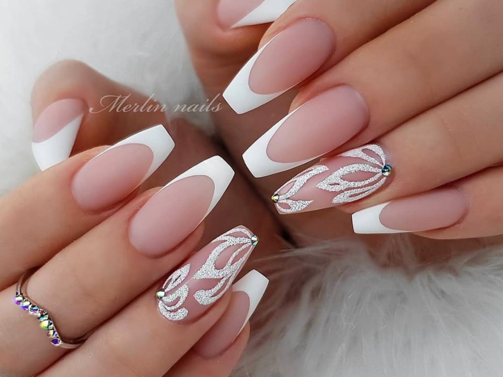 Natural with white accents and glitter design nails.