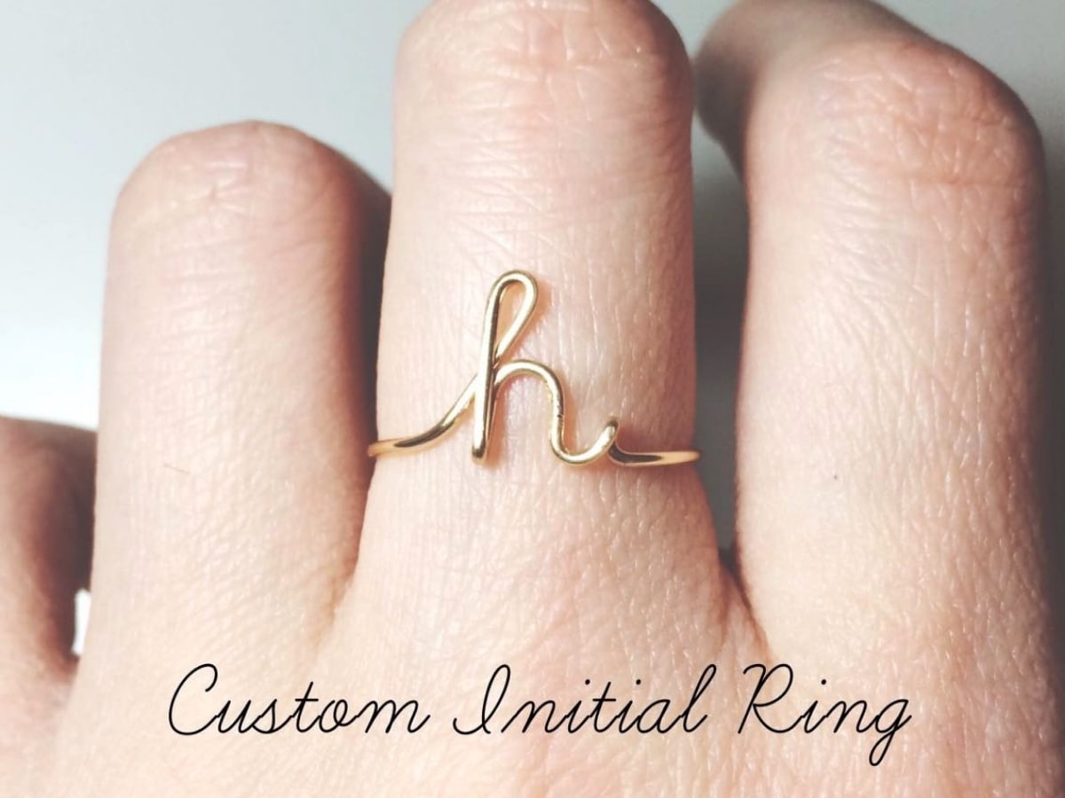 Gold ring shaped into a letter H.