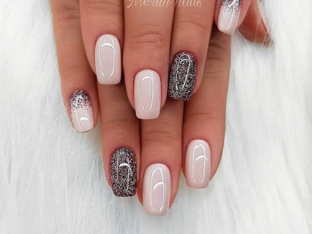Mixed glitter paint with light pink tone nails.