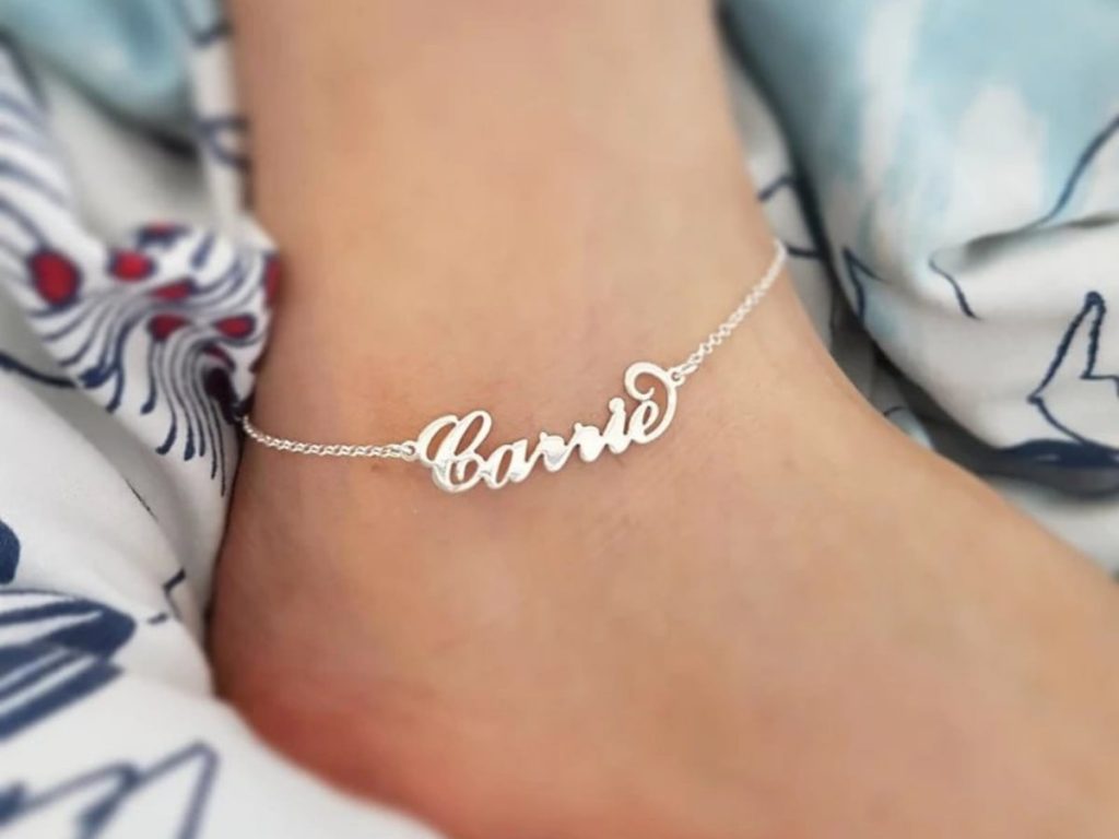 Personalized gold ankle bracelet with a name.