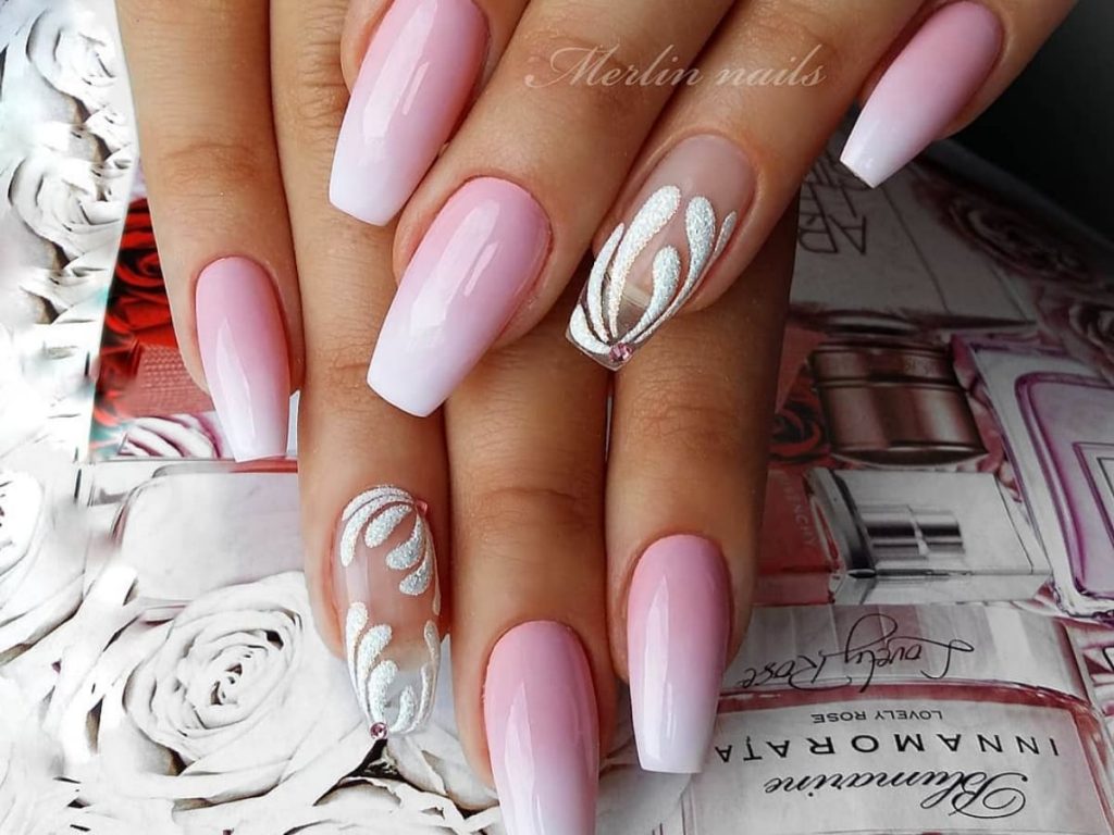 Pink faded to white wedding nails with glitter artwork.
