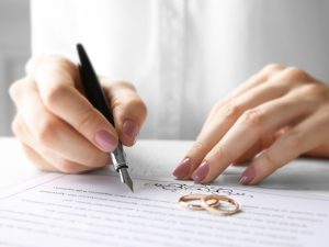 A person signing a marriage license.
