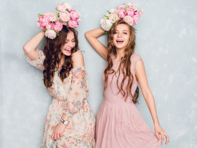 Two girls wearing semi formal dresses and flower headpieces