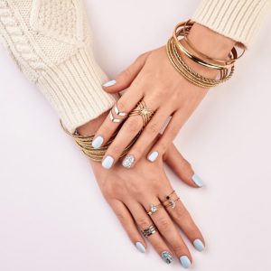 A picture of a hands with different rings on her fingers