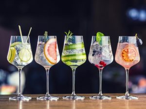 Wine glasses with different kinds of drinks and fruits in them