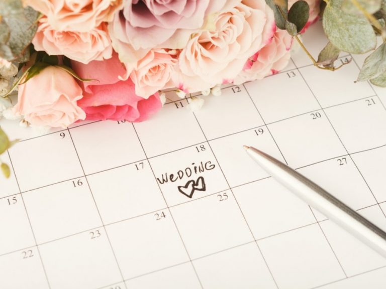 A calendar with a wedding date written on it
