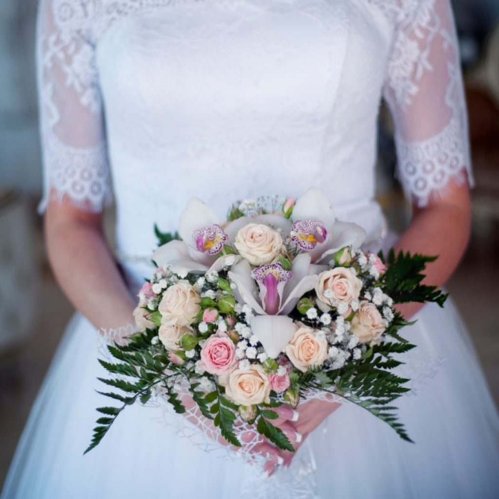 woman holding a bouquet of assorted flowers