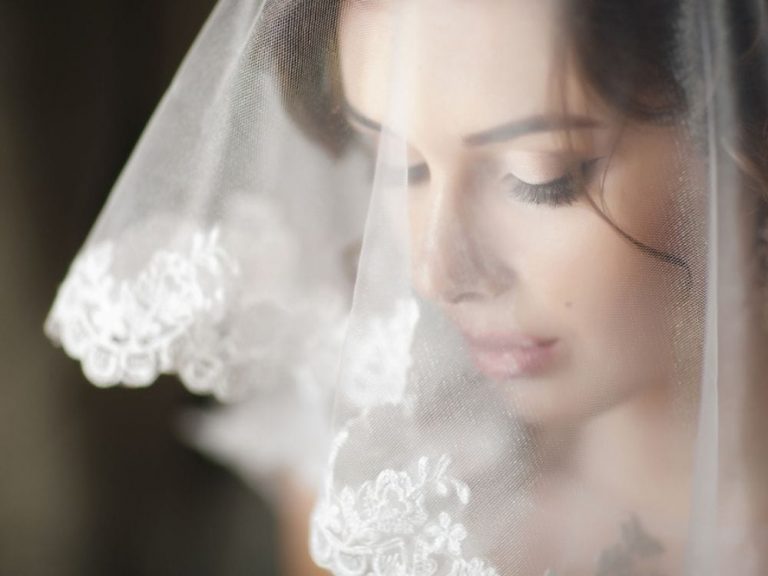 A close up of a woman in her wedding veil
