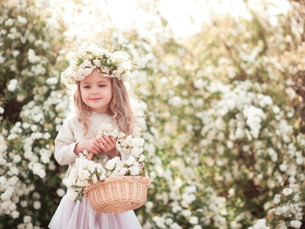 A flower girl holding a basket.
