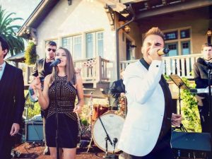 A band /emcee playing music at a wedding.